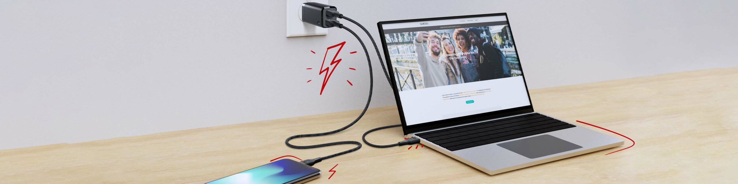 A laptop and smartphone sit on a desk while both are plugged into a charger in an outlet - red lightning bolt illustrations surround them